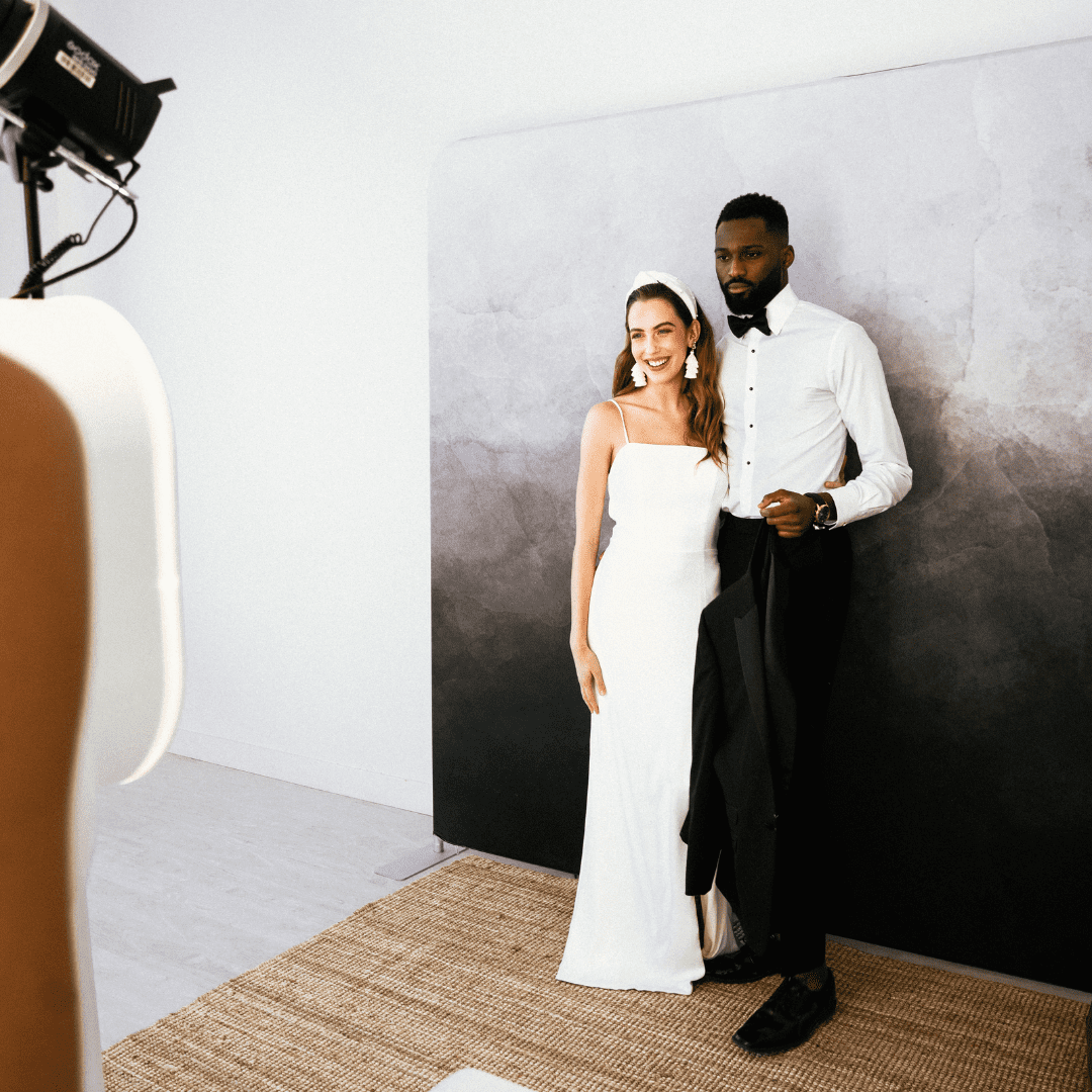 Couple posing in front of photo booth